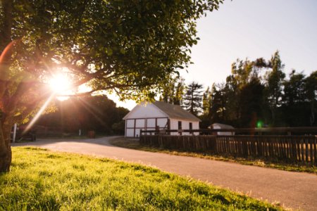 White And Grey House Beside Empty Road During Sunset