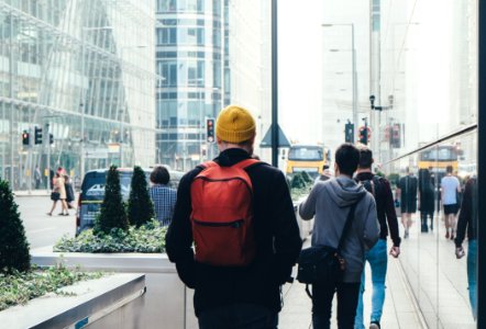 Man In Black Jacket And Carrying Red Backpack photo