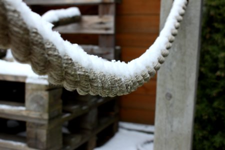 Snow Covered Rope And Wooden Pallets