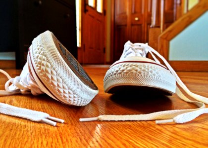 White Sneakers On Wooden Floor photo