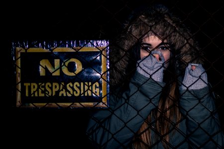 Woman Next To No Trespassing Sign photo