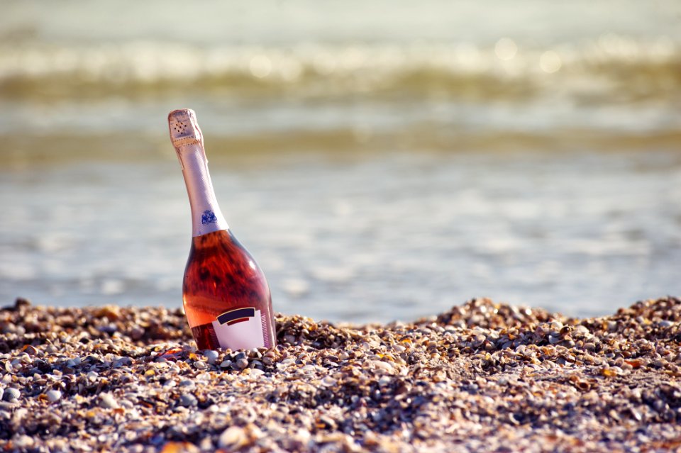 Sparkling Wine Bottle On Beach