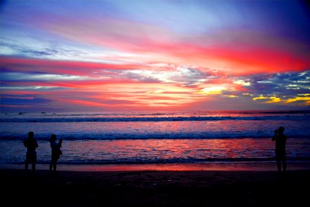 Silhouette Of People On Bali Beach At Sunset photo