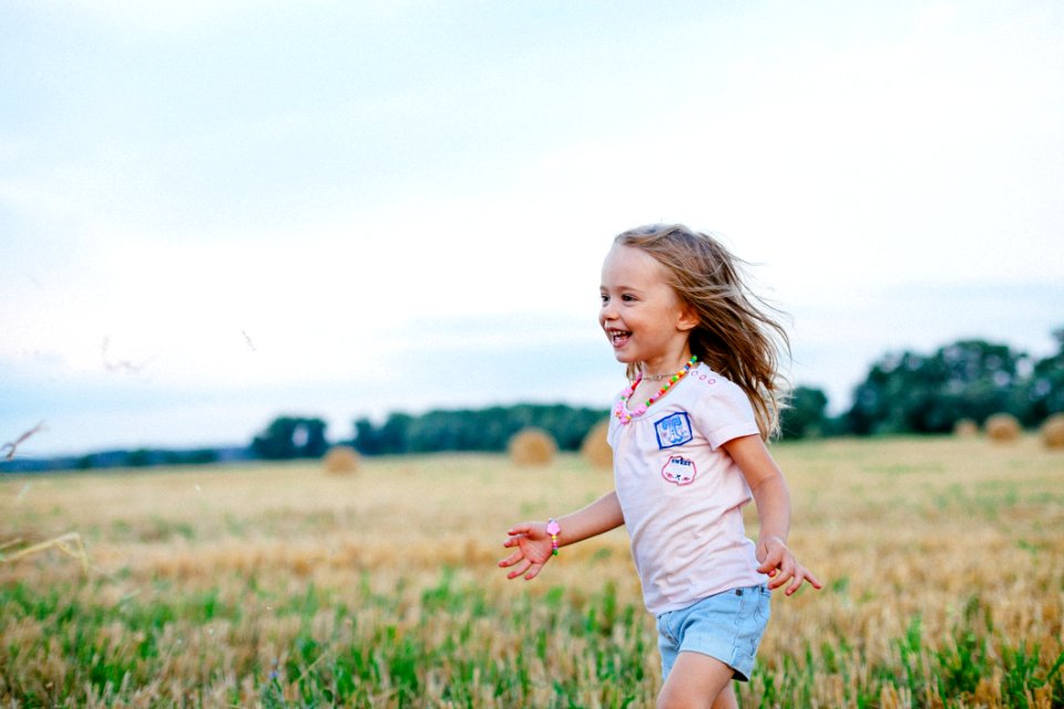 Carefree Young Girl In Stubble Field