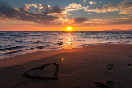 Heart In Sand On Beach At Sunset photo