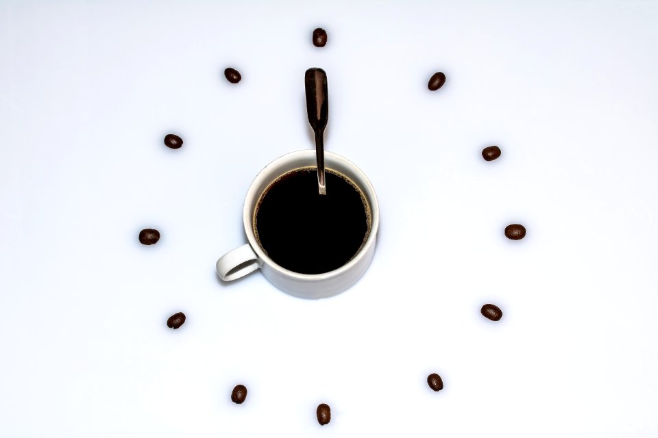 Cup Of Coffee Surrounded By Beans
