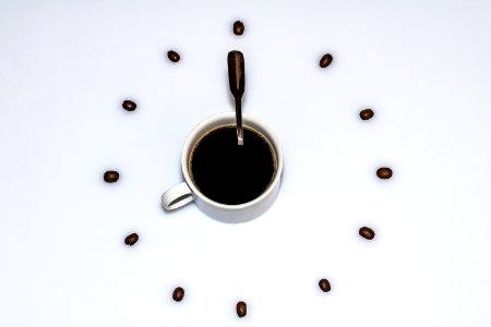Cup Of Coffee Surrounded By Beans photo