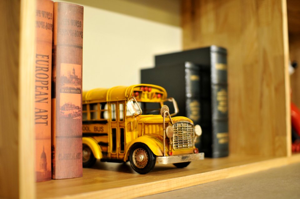 Toy School Bus On Bookshelf