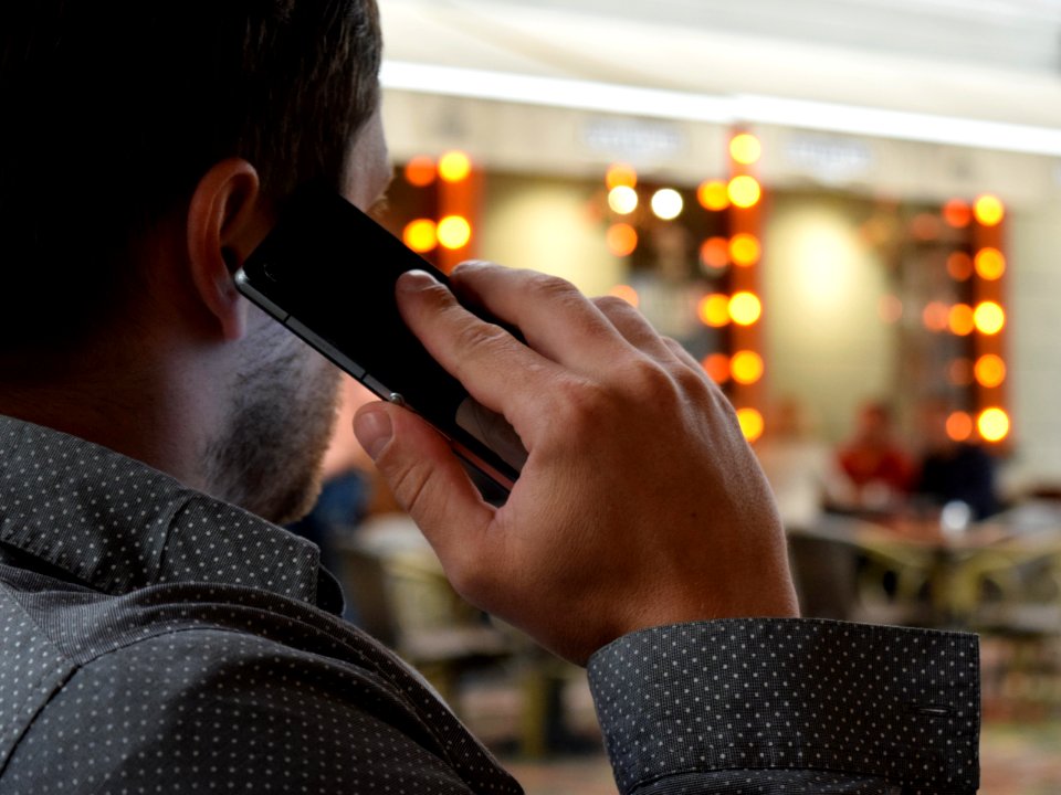 Person Using Phone Selective Focus Photography