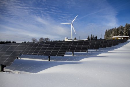 Solar Panels And Wind Turbine In Snow photo