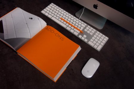 Orange Book In Distance With Silver Imac photo