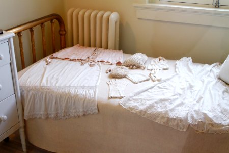 White Sleeveless Dress On White Mattress photo