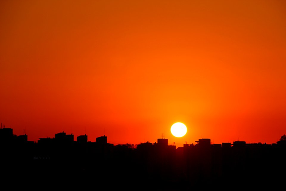 Silhouette Cityscape Against Romantic Sky At Sunset