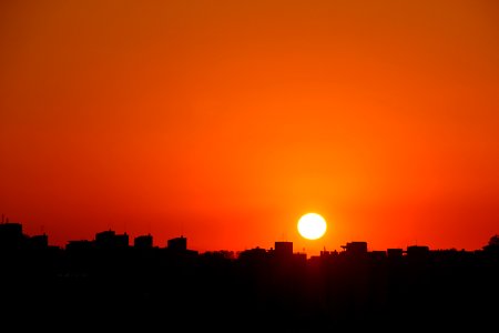 Silhouette Cityscape Against Romantic Sky At Sunset photo