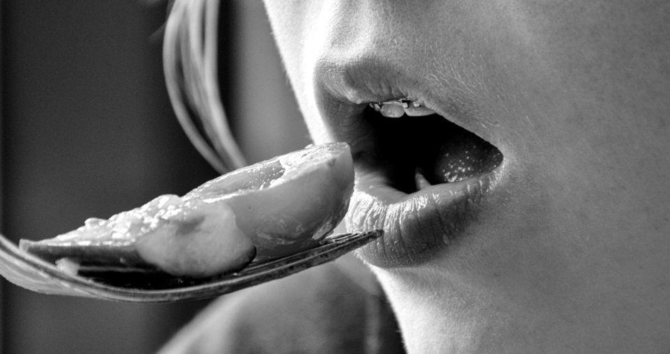 Girl Eating Food On Fork