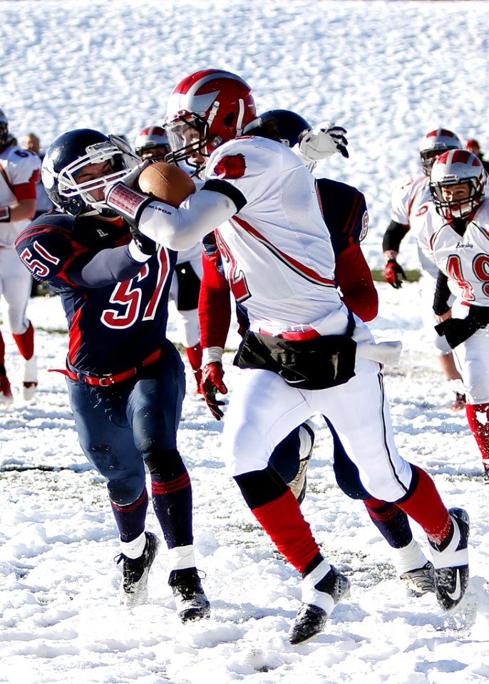 Football Players On Snowy Field