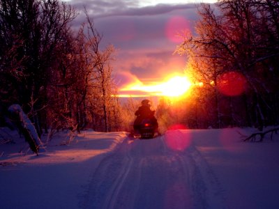 Snowmobile On Track At Sunset photo
