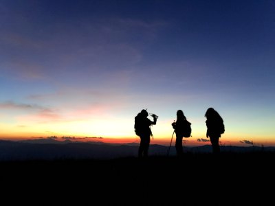 People On Mountain At Sunset