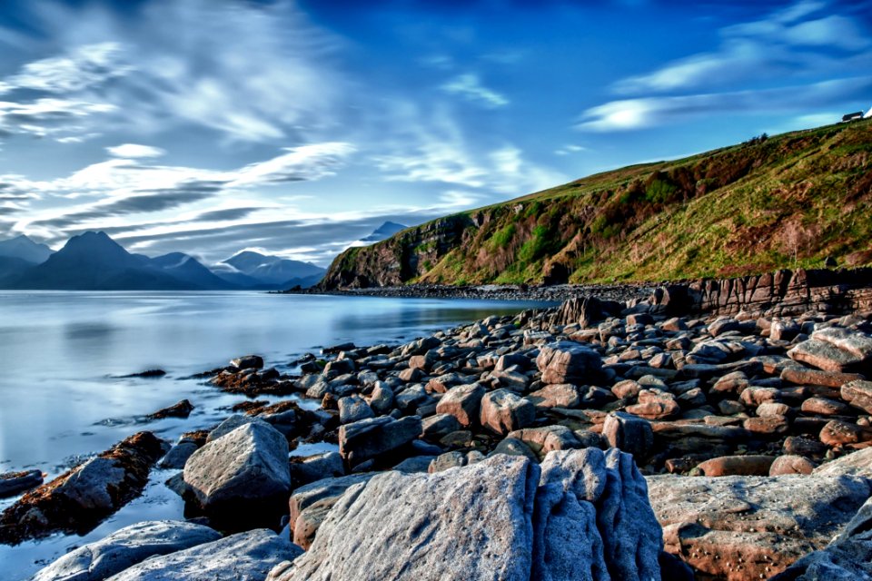 Big Rocks Near Ocean Under Blue Sky photo