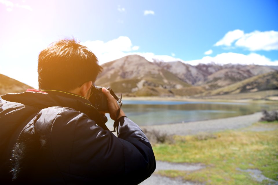 Photographer Taking Photo Of Landscape