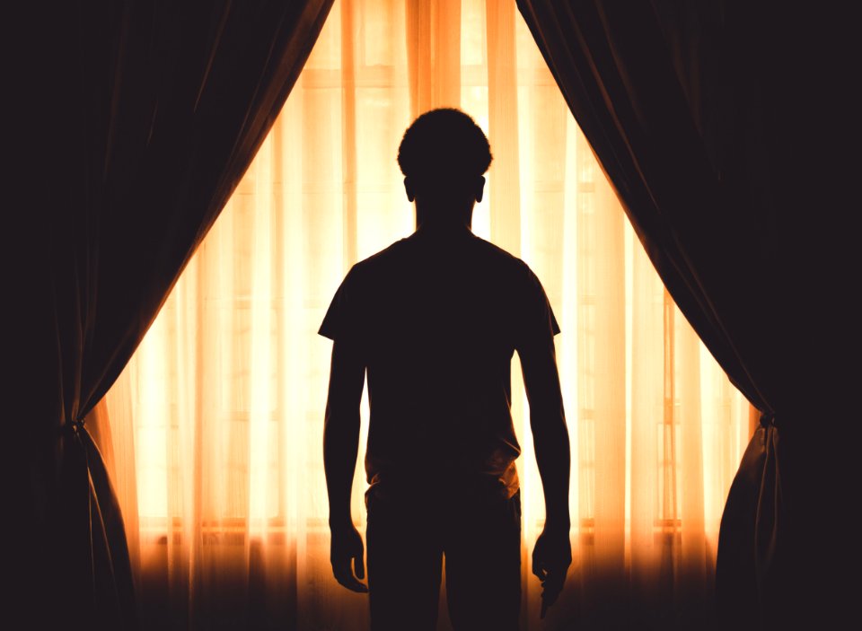 Silhouette Of Boy At Window