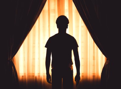 Silhouette Of Boy At Window