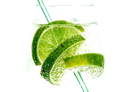 Glass With Clear Liquid And Limes photo