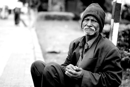 Homeless Man Sat In Street photo