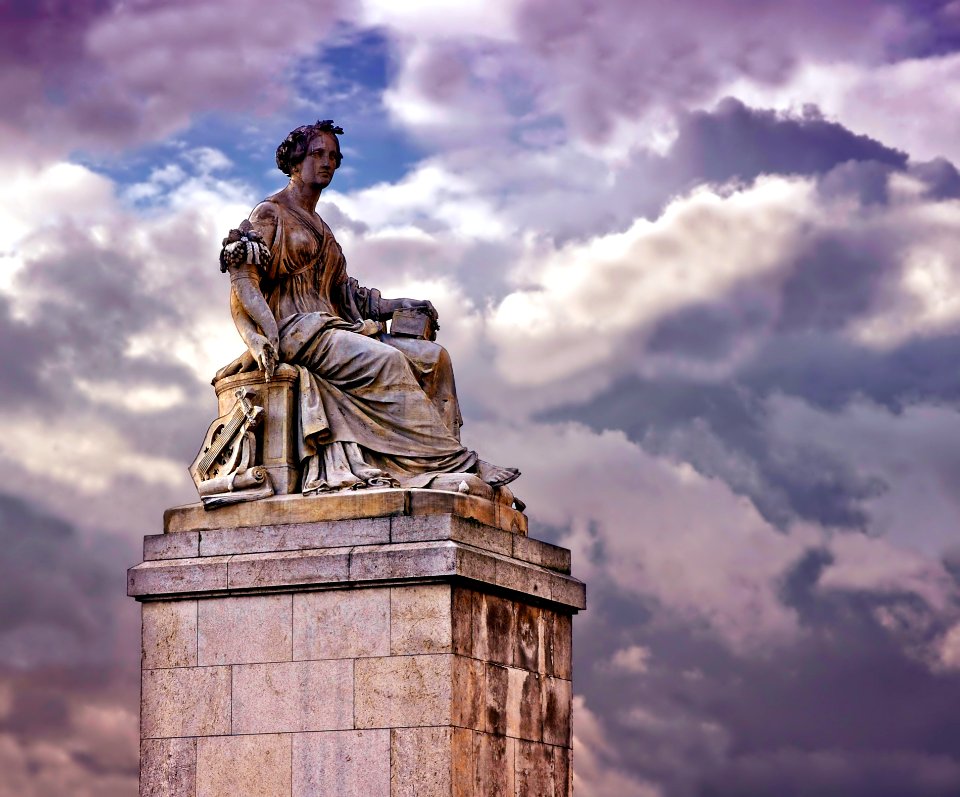 Person In White Dress Ceramic Statue Under Blue Cloudy Sky During Daytime