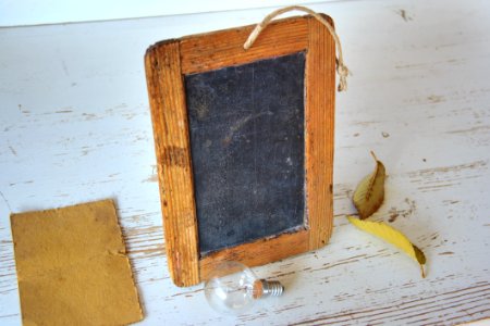 Brown Rectangular Wooden Picture Frame Near Light Bulb photo