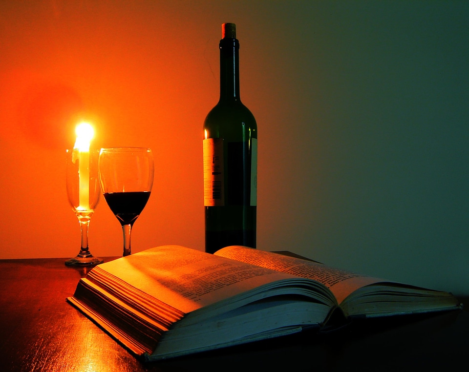 Glass of wine book candle