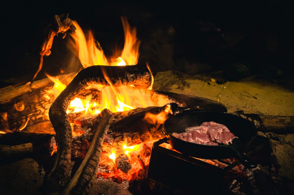 Campfire Cooking Meat In Skillet