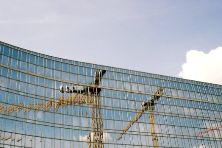TOWER CRANES REFLECTED IN GLASS