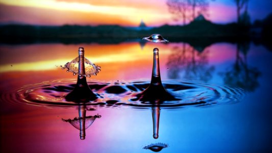 Water Splashing In Pool At Sunset