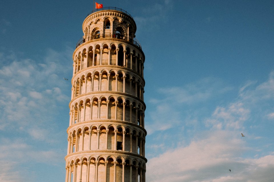 PISA TOWER WITH BIRDS AND PLANE