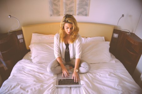 Woman Working Hotel Bed photo
