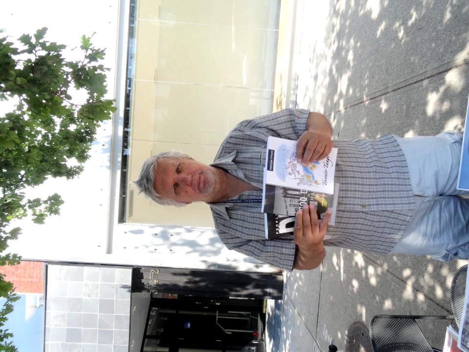 Journalist Nebojsa Knevic Holds Up Three Of The Books He Authored 2017 08 09