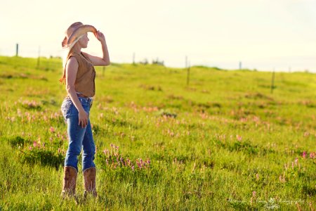 Woman Wearing Brown Cowboy Boots And Vest With Hat Under Blue Sky During Daytime photo