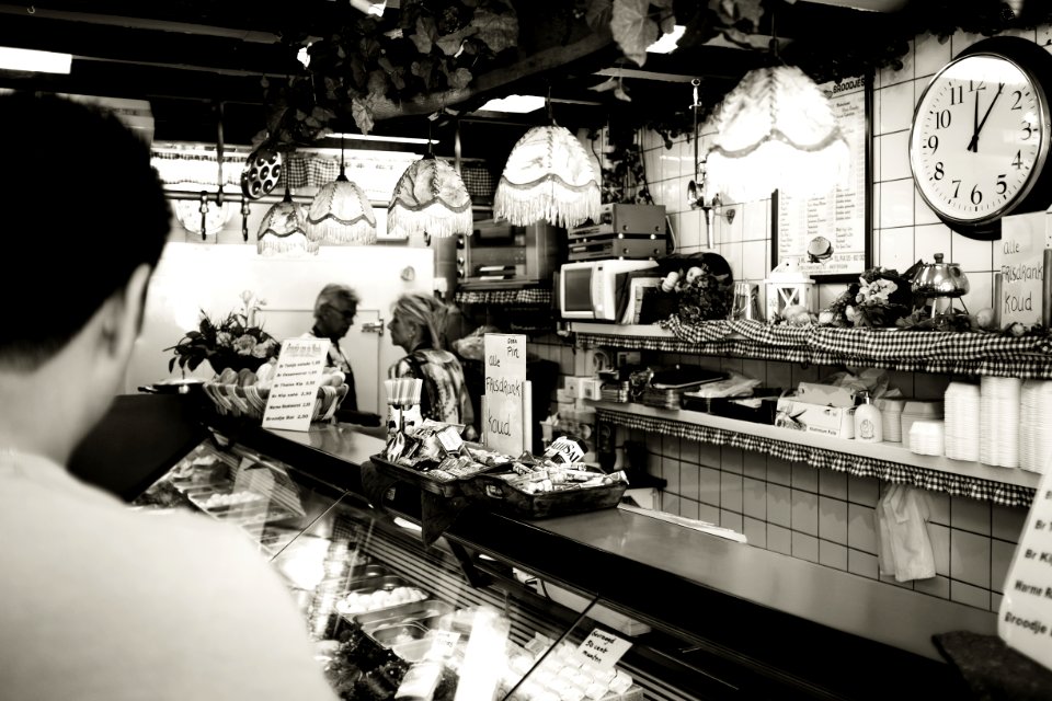 Man Wearing White Shirt In A Cafe In Gray Scale Photography photo