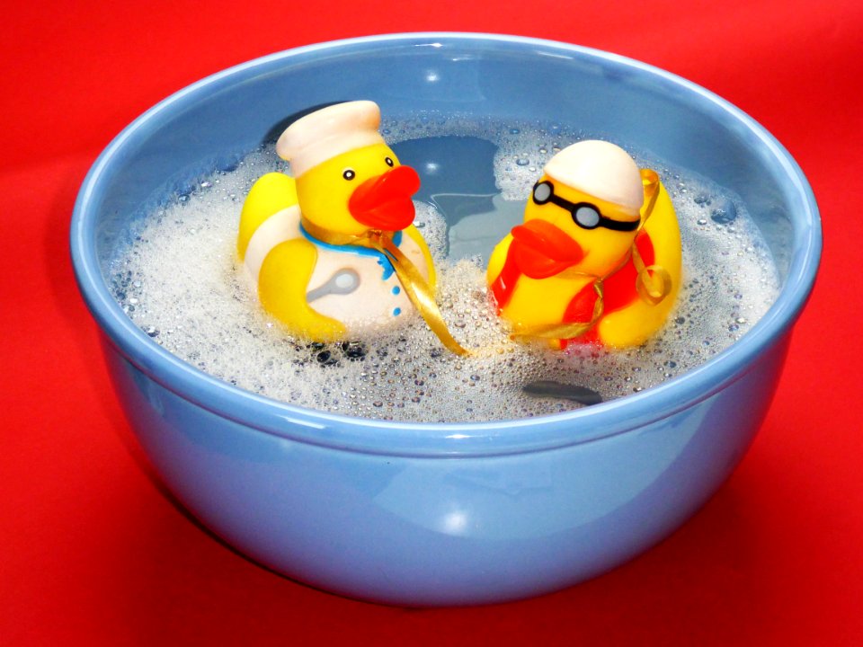 2 Rubber Ducky On Blue Ceramic Bowl