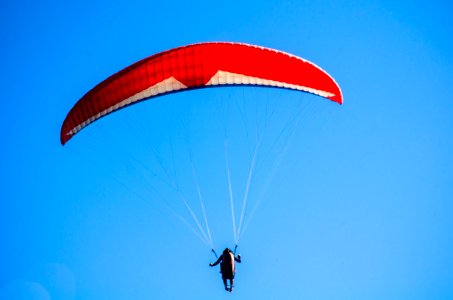 Person Using Red Parachute On Mid Air