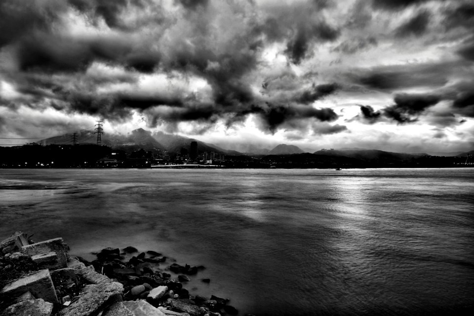 Grayscale Photo Of Sea During Cloudy Sky At Daytime