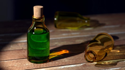 Green Liquid On Clear Glass Bottle With Cork photo
