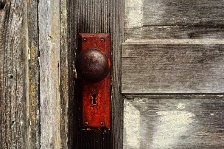Rusty Door Knob On Wooden Door photo