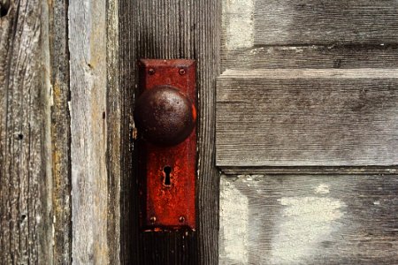 Rusty Door Knob On Wooden Door