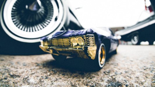 Toy Car Next To Real Ones