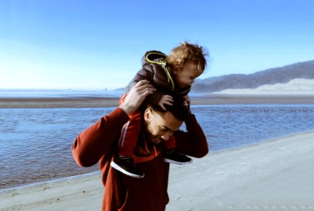 Dad Carrying Son On His Shoulders