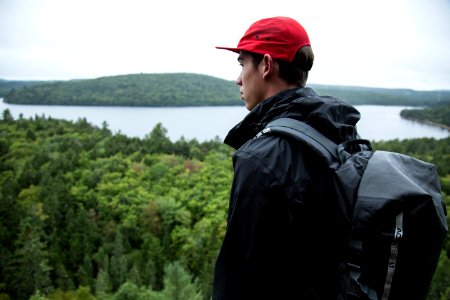 Man With Backpack In Woods