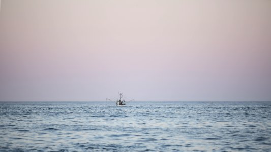 Fishing Boat On Water At Sunset