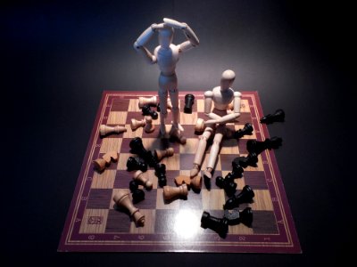 Wood Puppets On Chessboard photo